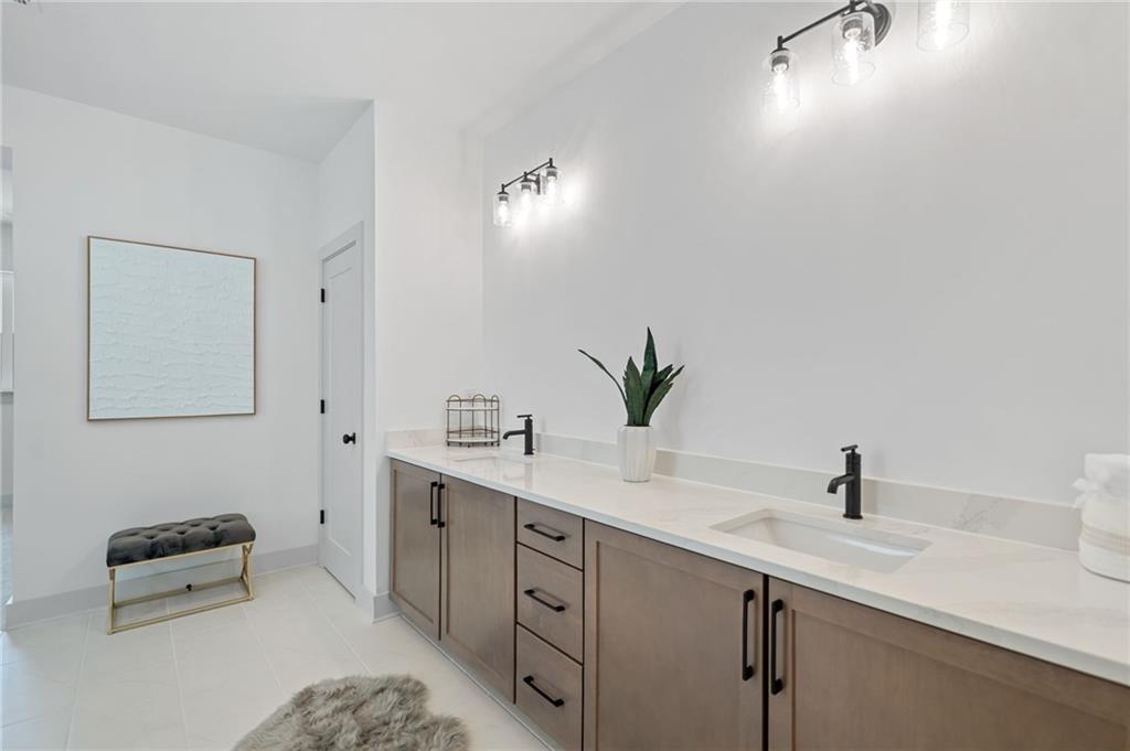 461 Maypop Lane Woodstock, GA 30188 - Photo 16 of 18 a bathroom with a sink and a mirror