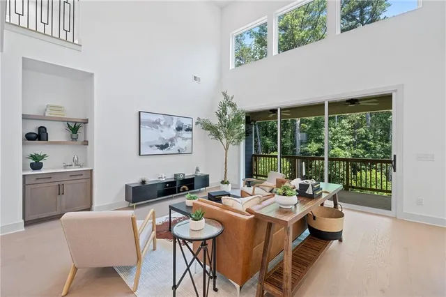 a dining room with furniture a large window and a potted plants