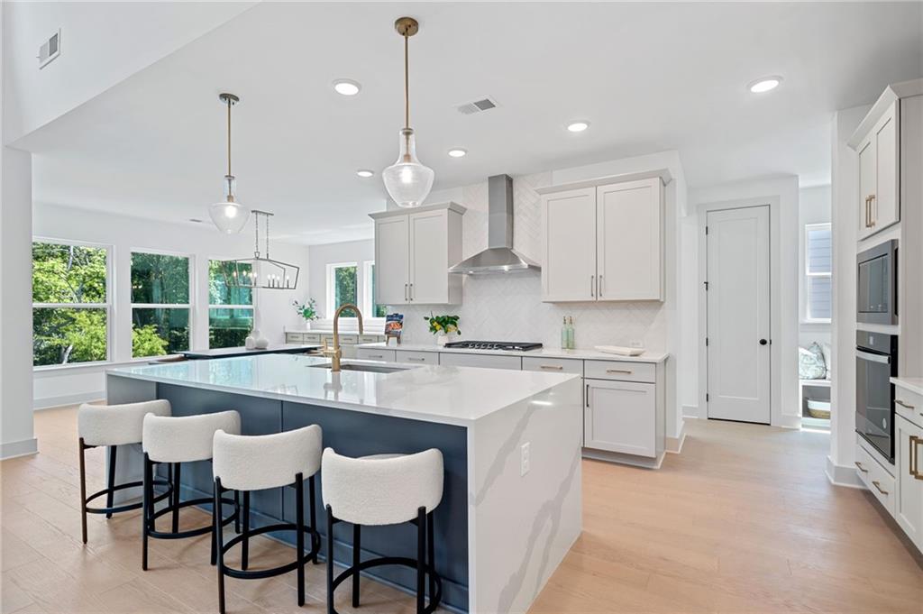 461 Maypop Lane Woodstock, GA 30188 - Photo 3 of 18 a kitchen with stainless steel appliances granite countertop a stove a sink a refrigerator a center island a stove and a cabinets