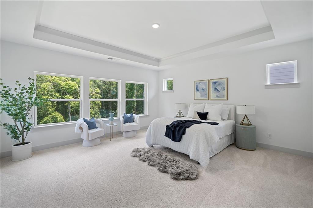 461 Maypop Lane Woodstock, GA 30188 - Photo 4 of 18 a spacious bedroom with a bed and a couch