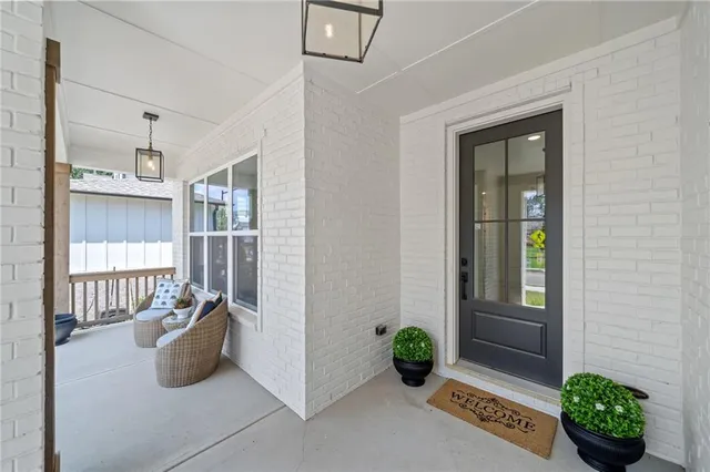 a view of an entryway with wooden floor and door
