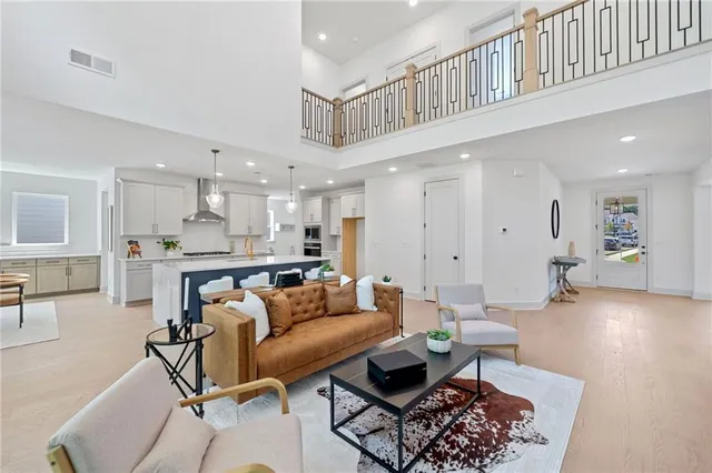a living room with furniture and kitchen view