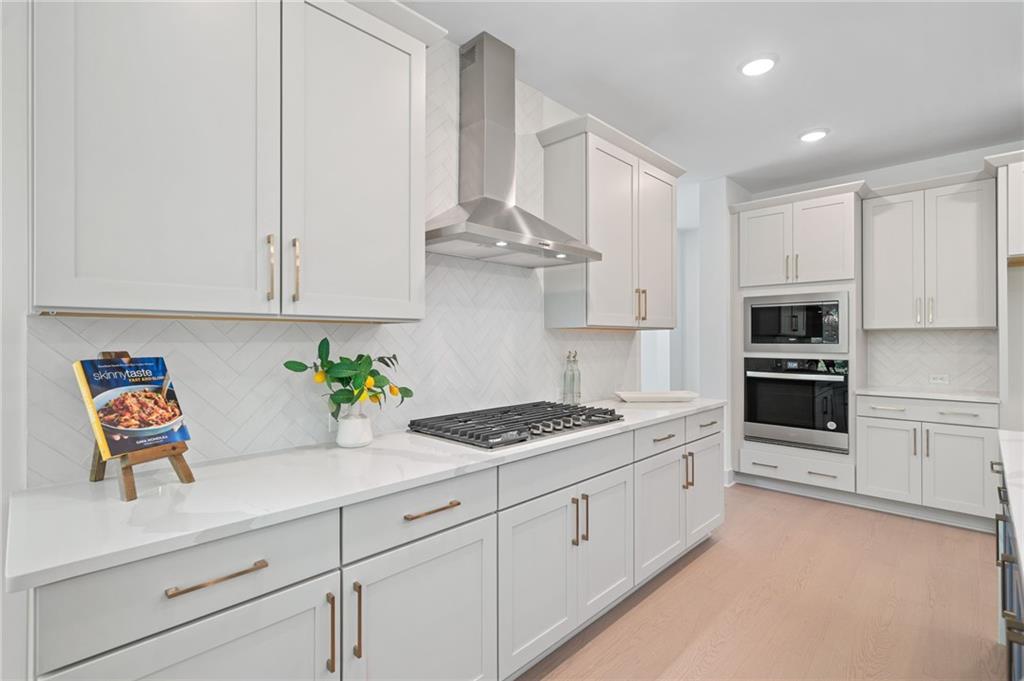 461 Maypop Lane Woodstock, GA 30188 - Photo 9 of 18 a kitchen with stainless steel appliances granite countertop white cabinets a stove a sink and dishwasher