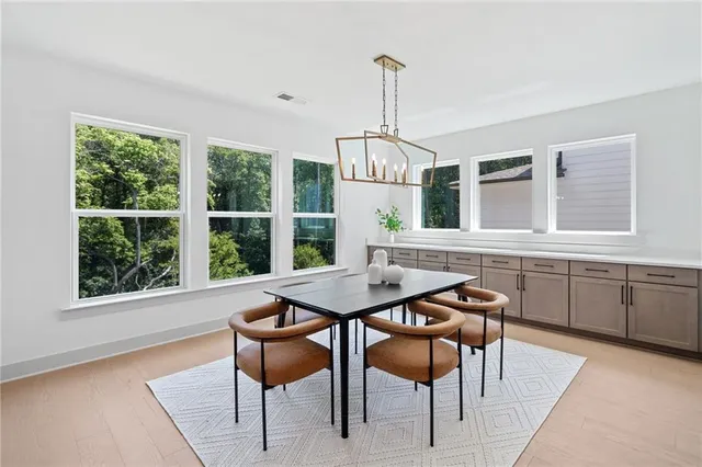 a view of a dining room with furniture window and wooden floor