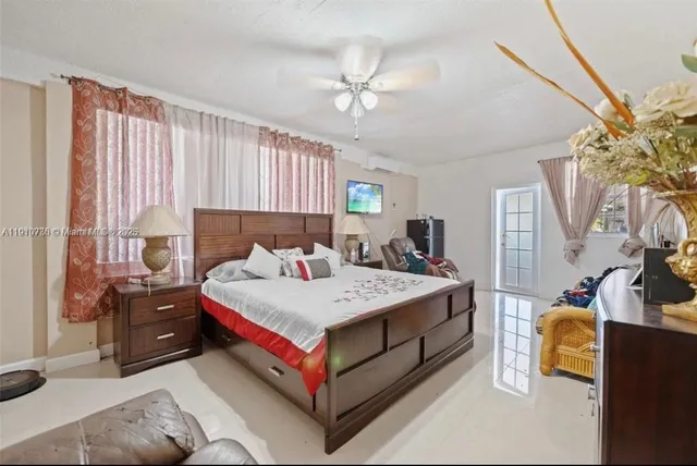 a living room with a bed furniture and a window