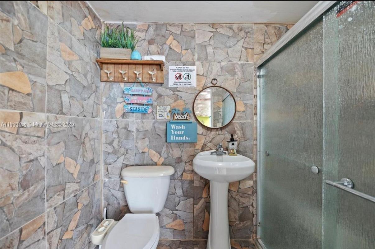 20235 Southwest 172nd Avenue Miami, FL 33187 - Photo 15 of 30 a bathroom with a toilet sink and mirror