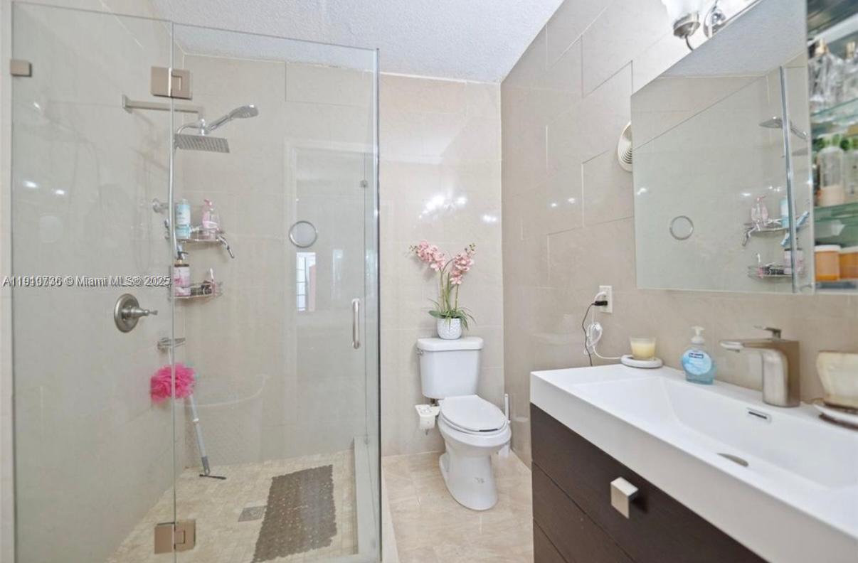 20235 Southwest 172nd Avenue Miami, FL 33187 - Photo 17 of 30 a bathroom with a sink and a mirror