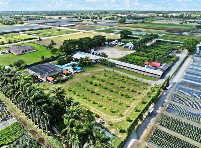 an aerial view of a house with a garden and lake view