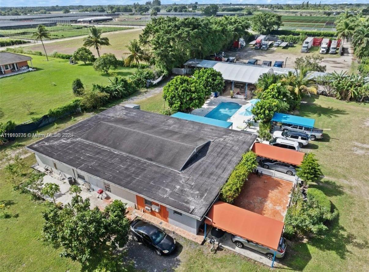 20235 Southwest 172nd Avenue Miami, FL 33187 - Photo 23 of 30 an aerial view of a house with a garden and lake view