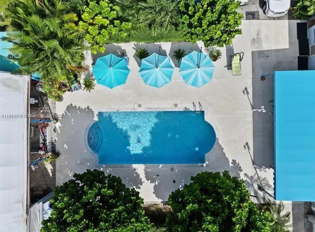 an aerial view of a house with a yard and garden