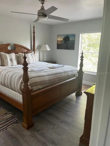 a bedroom with a bed and a window