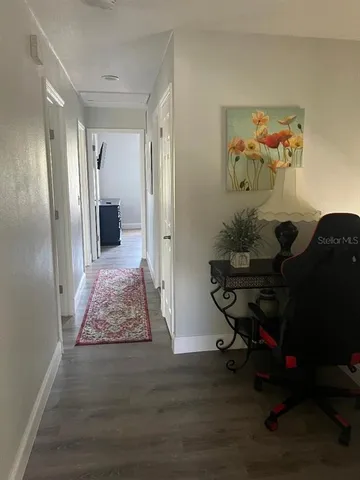 a workspace with wooden floor and furniture