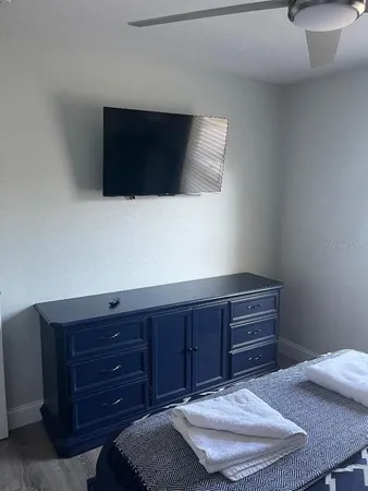 a room with a bed and a television