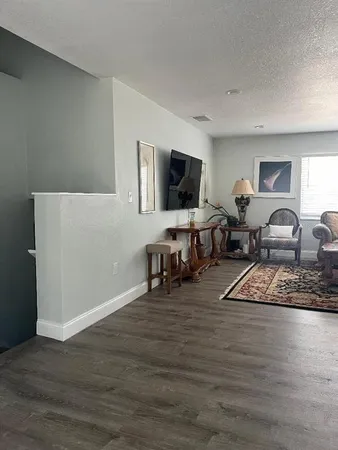 a bedroom with furniture and a flat screen tv