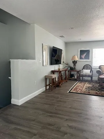 a bedroom with furniture and a flat screen tv