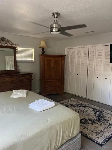 a bedroom with a bed and a dresser