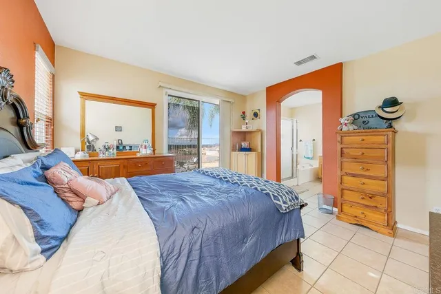 a bedroom with a bed and dresser