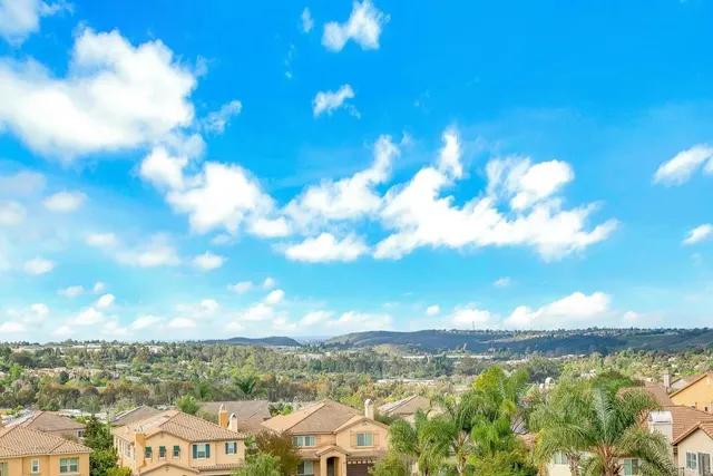 a view of a lake with houses in the back