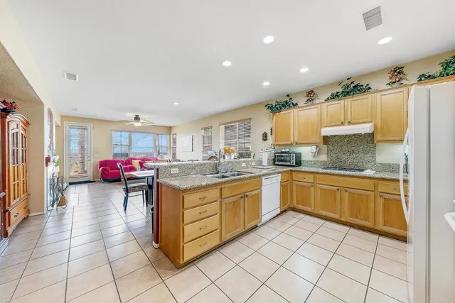 a kitchen with stainless steel appliances granite countertop a sink and cabinets