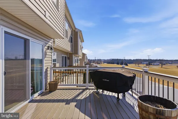a view of a balcony with chair and wooden floor
