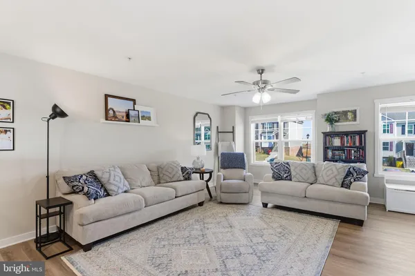 a living room with furniture and a ceiling fan
