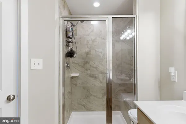 a bathroom with a shower and a sink