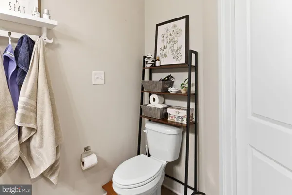 a white toilet sitting next to a bathroom sink