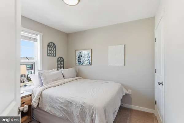 a bedroom with a bed and a night stand