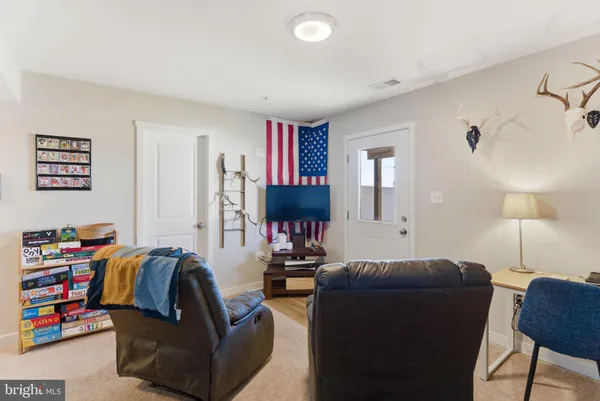 a living room with furniture and a lamp
