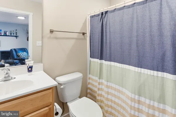a white toilet sitting next to a bathroom sink
