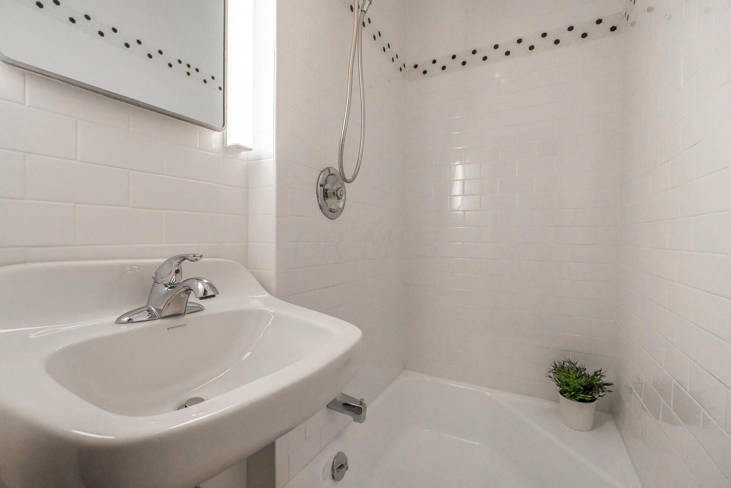 168 Fallis Road Columbus, OH 43214 - Photo 27 of 43 2-piece half bath with sink & shower accessible from the primary bedroom