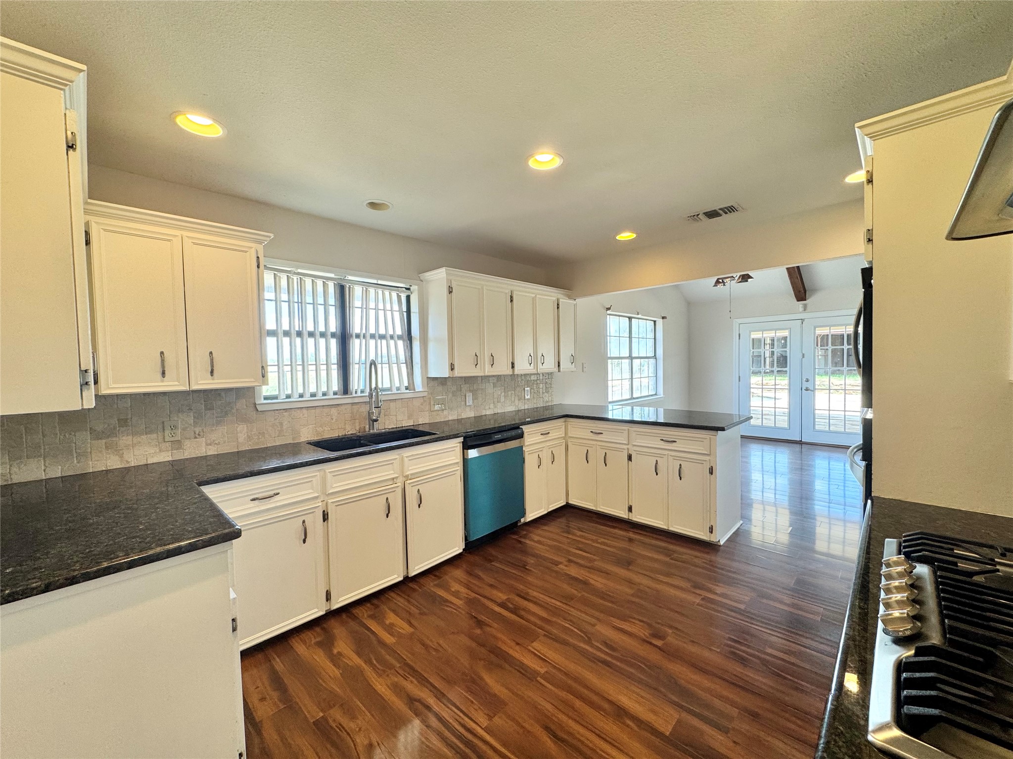 18512 Carlson Lane Elgin, TX 78621 - Photo 8 of 29 Rich wood floors contrast beautifully with classic cabinetry in this open kitchen layout.