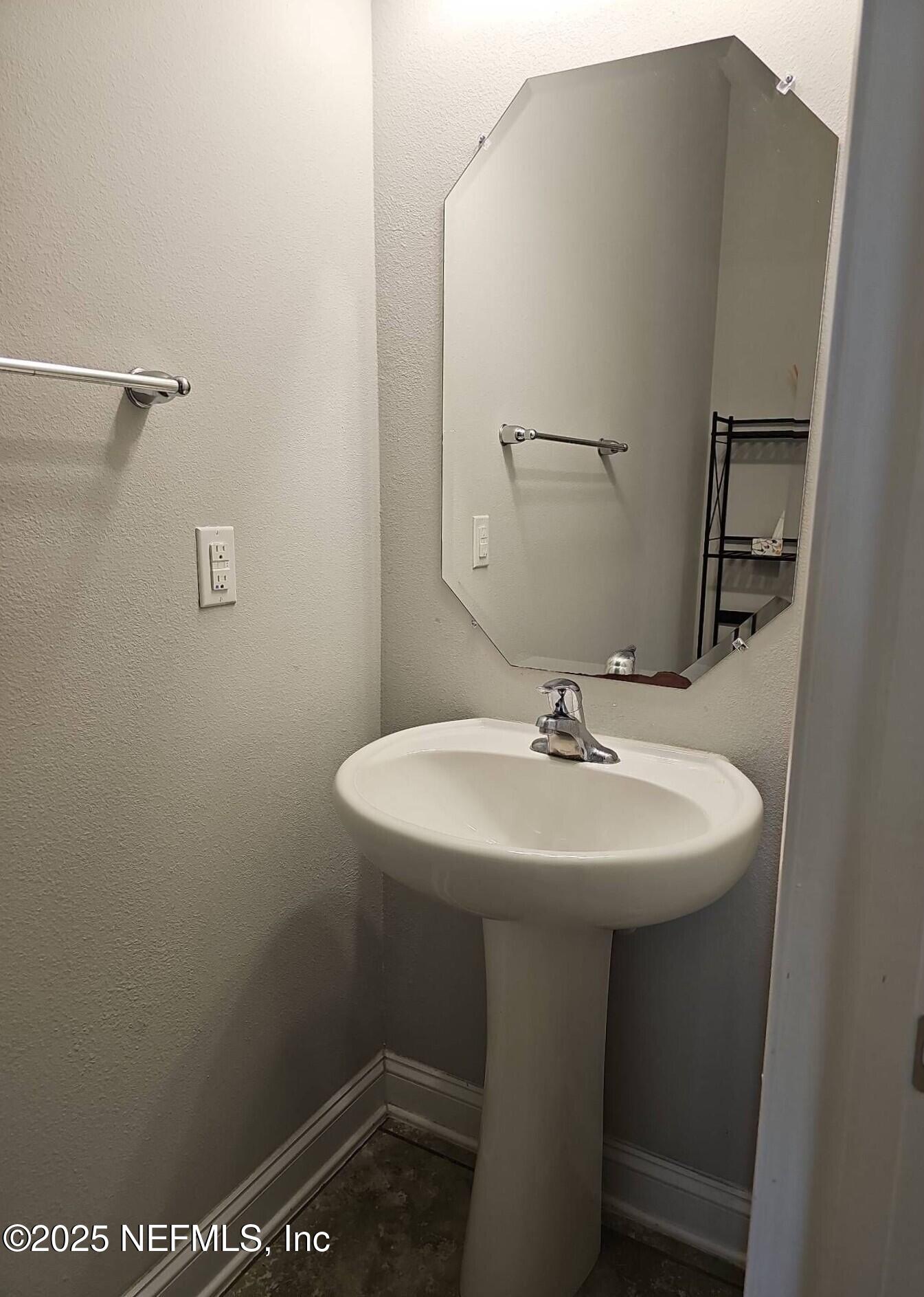 61 Boulder Rock Way St. Augustine, FL 32092 - Photo 11 of 20 a bathroom with a sink a mirror and a toilet