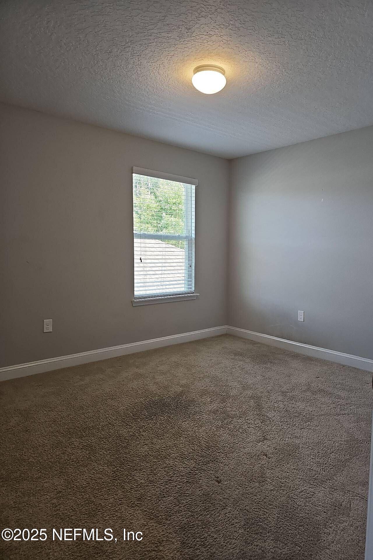 61 Boulder Rock Way St. Augustine, FL 32092 - Photo 18 of 20 an empty room with a window