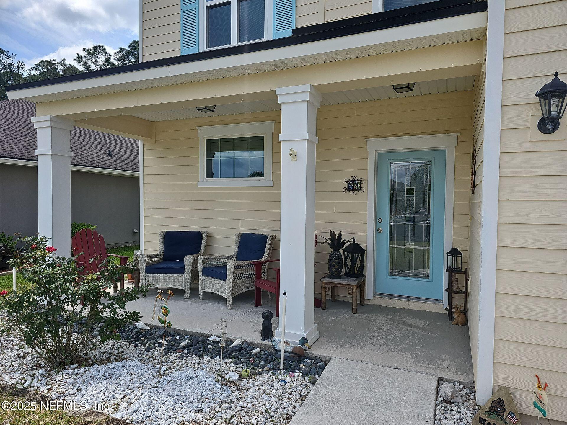 61 Boulder Rock Way St. Augustine, FL 32092 - Photo 19 of 20 a view of a patio with table and chairs and potted plants