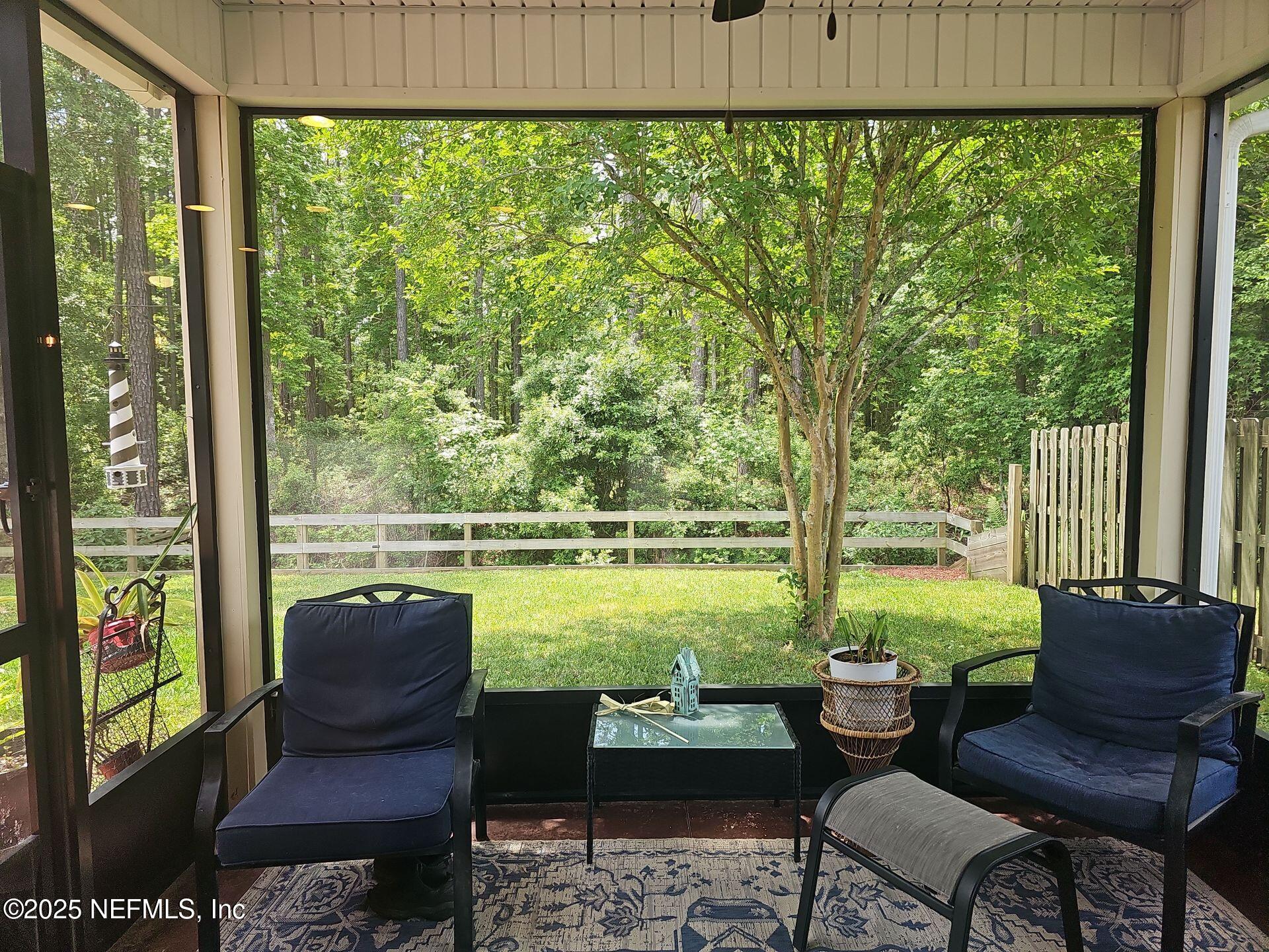 61 Boulder Rock Way St. Augustine, FL 32092 - Photo 2 of 20 a living room with large windows and a table
