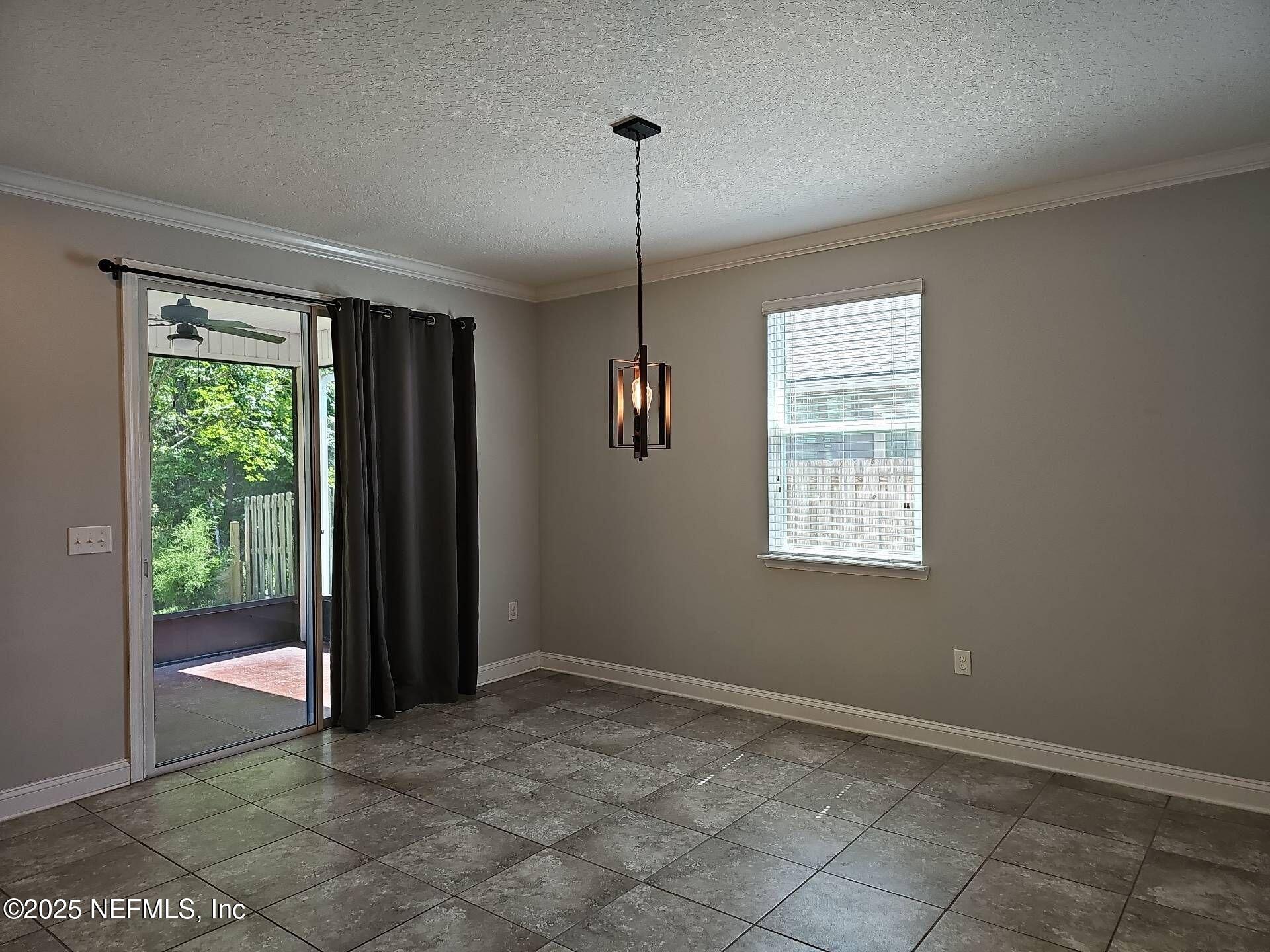 61 Boulder Rock Way St. Augustine, FL 32092 - Photo 4 of 20 a view of empty room with floor to ceiling window