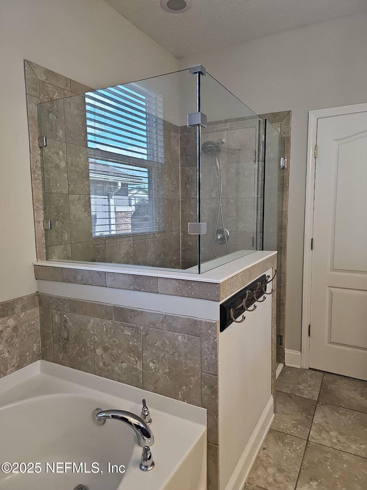 61 Boulder Rock Way St. Augustine, FL 32092 - Photo 8 of 20 a bathroom with a tub sink and mirror