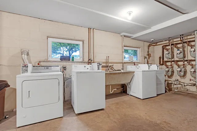 a room with a sink washer and dryer