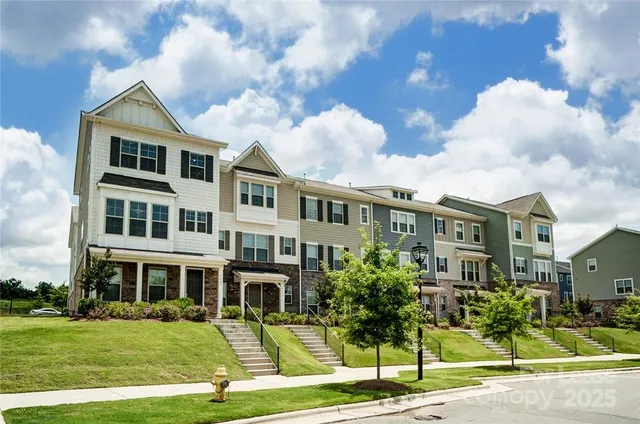 a front view of a residential apartment building with a yard