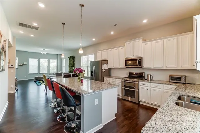 a large kitchen with a table and chairs in it