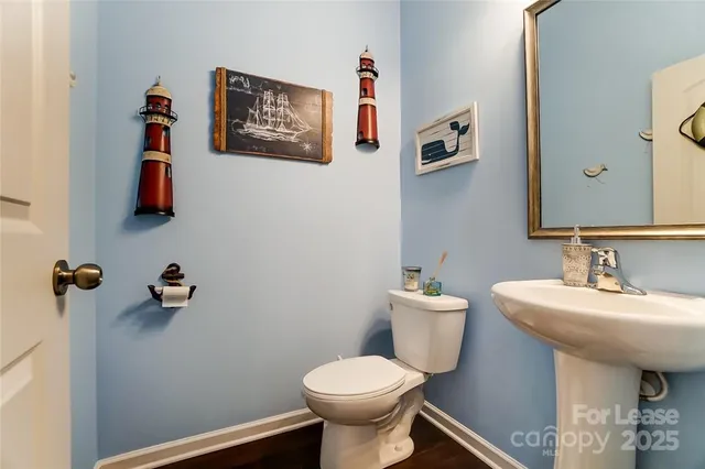 a bathroom with a sink mirror and toilet