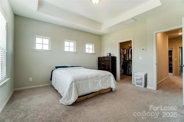 a spacious bedroom with a bed and a walk in closet