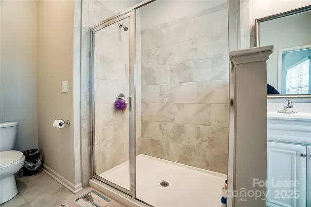a bathroom with a shower and a toilet