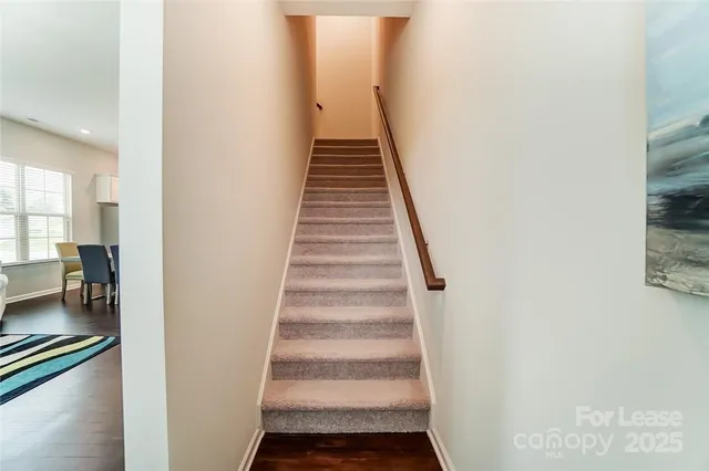 a view of a hallway with wooden floor and entryway