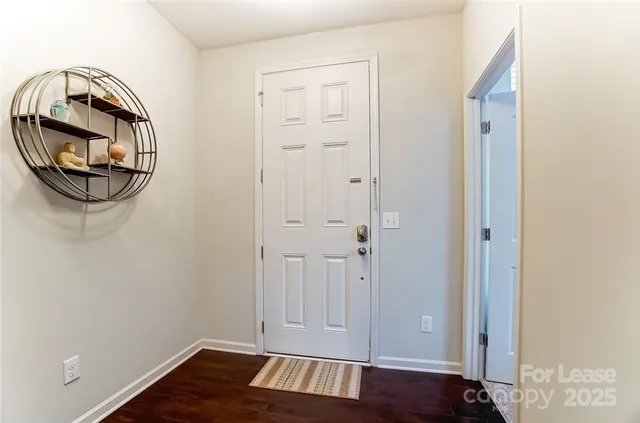 a view of an entryway with wooden floor
