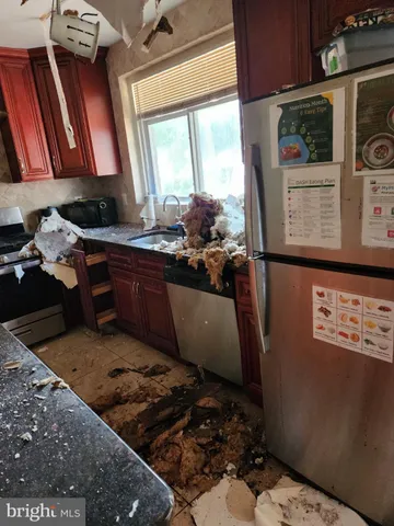 a living room with hard wood floors and a fireplace
