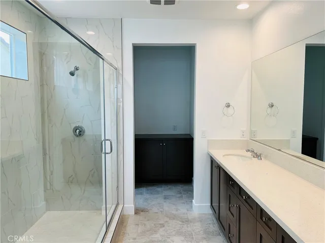 a bathroom with a double vanity sink and mirror