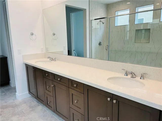a bathroom with a sink double vanity and a mirror