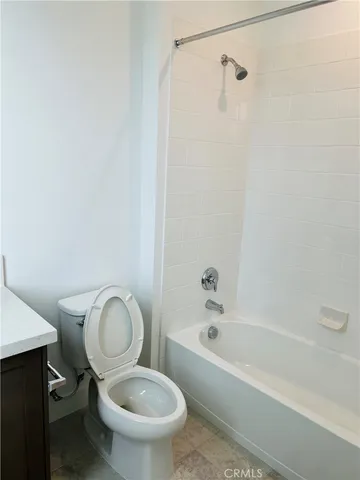 a bathroom with a granite countertop toilet a sink and bathtub